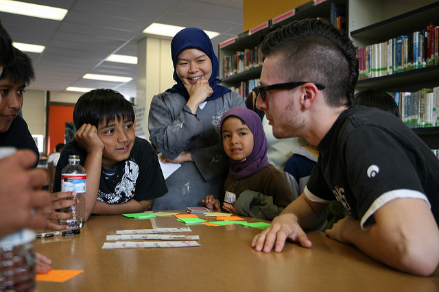 Fellows and students discussing project at a table